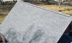 Finished gray architectural shingle roof installed by J. Carnes & Son Roofing in New Hampshire, with a continuous ridge vent running along the peak for attic ventilation